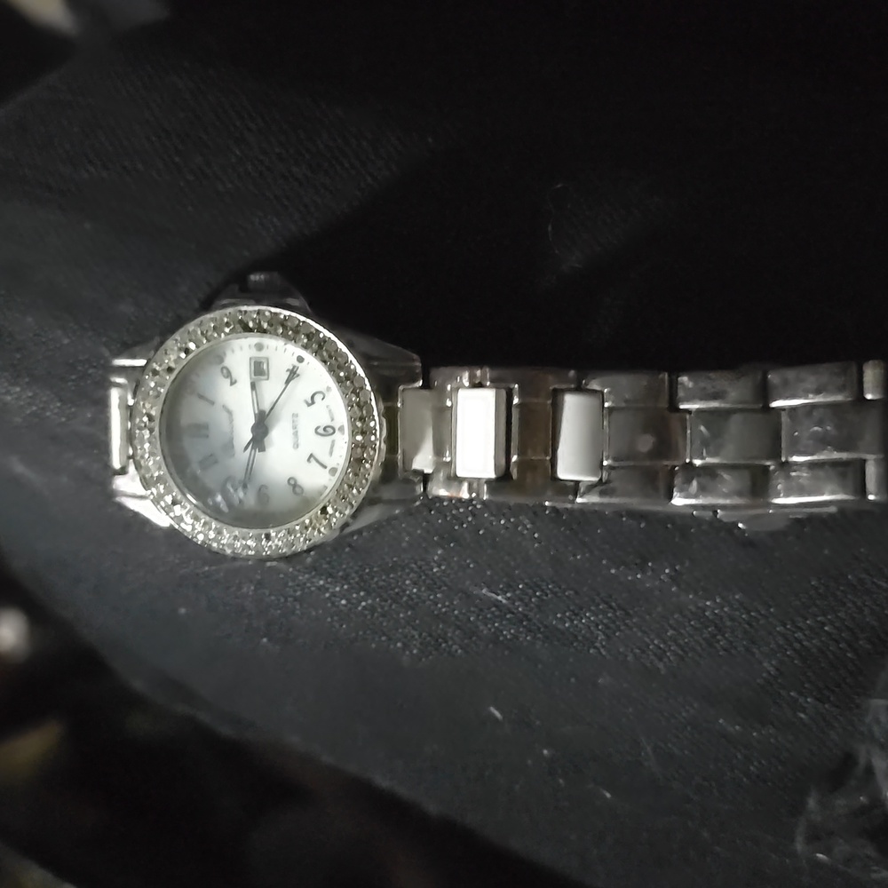 Womans silver watch with mother of pearl face